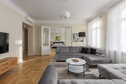 a living room with a couch and a table at K1820 Family apartments in Rīga