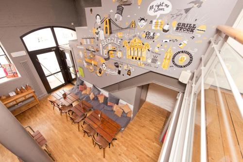 a room with chairs and a wall with stickers on it at YHA Bristol in Bristol