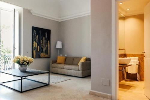 a living room with a couch and a table at Relais Corte Degli Aragonesi in Ischia