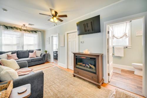 a living room with a couch and a fireplace at Family-Friendly Main St Gloucester Apt with Balcony! in Gloucester