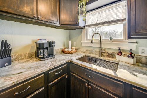 a kitchen with a sink and a coffee maker at Family-Friendly Main St Gloucester Apt with Balcony! in Gloucester