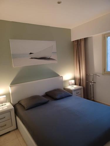 une chambre avec un lit avec deux oreillers dessus dans l'établissement 2 pièces en bord de mer avec piscine et jardin, à Théoule-sur-Mer