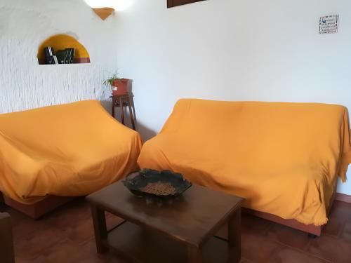 a room with two beds and a table at Los Jazmines in Benalúa de Guadix