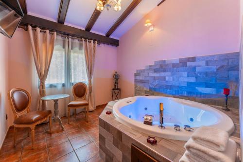 a bathroom with a large tub in a room at Sierra Palomera in Camañas