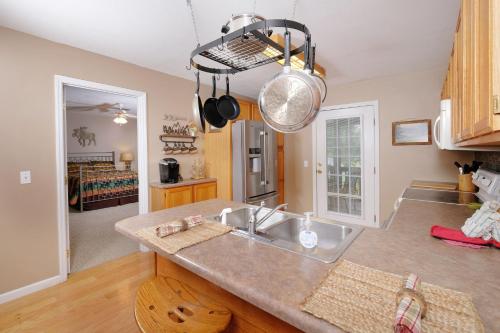 a kitchen with a sink and a counter at Conveniently located in Pigeon Forge, spacious & clean 3 bedroom! in Pigeon Forge