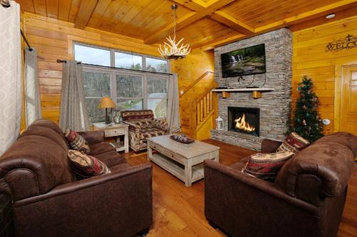 a living room with two couches and a fireplace at Hot tub, pool table, and AMAZING VIEW! Gorgeous! in Gatlinburg