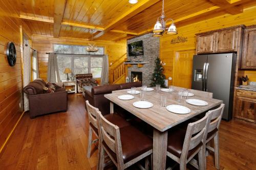 a kitchen and dining room with a table and chairs at Hot tub, pool table, and AMAZING VIEW! Gorgeous! in Gatlinburg
