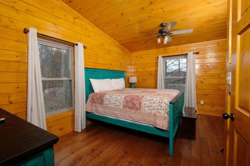 a bedroom with a bed and two windows at Hot tub, pool table, and AMAZING VIEW! Gorgeous! in Gatlinburg