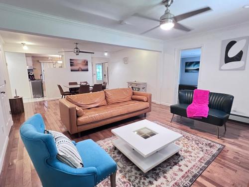 a living room with a couch and two chairs and a table at Modern and spacious villa close to NYC/Brooklyn/Queens/Garden City in Westbury
