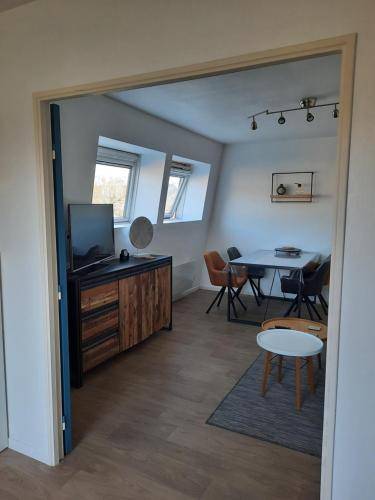 un salon avec une table et une télévision dans l'établissement Appartement 40M2, 1 chambre, à Fontainebleau