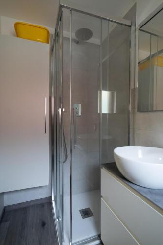 a bathroom with a glass shower and a sink at Girasole in Chioggia