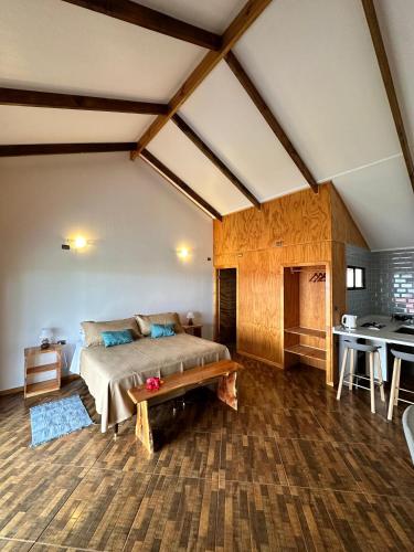 a bedroom with a bed and a table in a room at Cabañas Anavai Rapa Nui in Hanga Roa
