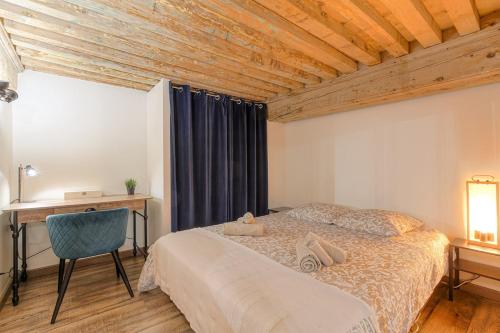 a bedroom with a bed and a desk and a table at Appartement "Le Canut" Croix-Rousse Lyon Centre in Lyon