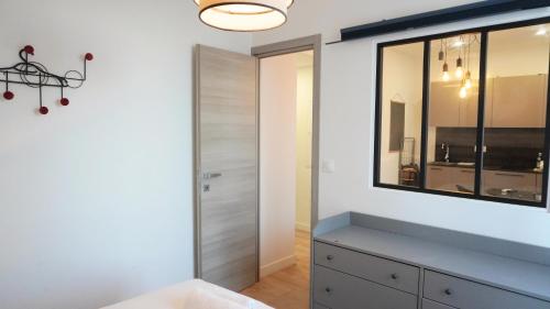 une chambre avec une commode et un miroir dans l'établissement Proche Carlton & Croisette, Appartement 301 - Palmazur Vacances, à Cannes