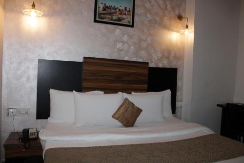 a bedroom with a bed with white pillows at Residency Hotel Lekki Chevron in Lekki