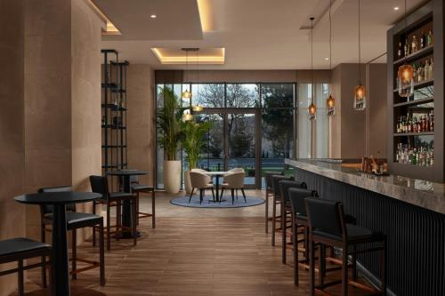 a bar with chairs and tables in a restaurant at Cappadocia Marriott Hotel in Nevsehir