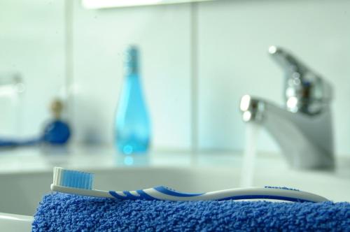 a toothbrush sitting on top of a blue towel at Felshof - Weingut & Gästehaus in Sommerhausen