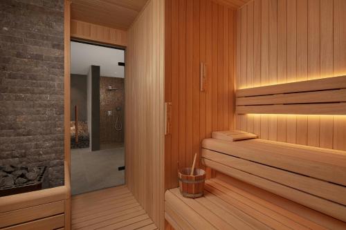 a bathroom with a sauna with wooden walls and wood floors at Cappadocia Marriott Hotel in Nevsehir