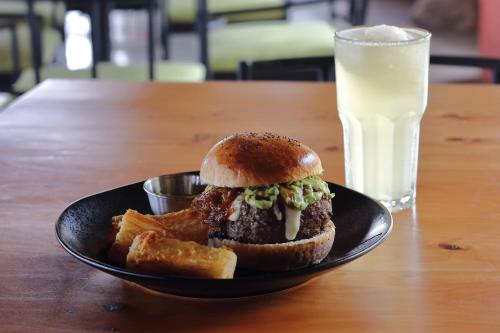 a sandwich and french fries on a plate with a glass of milk at Rancho Amalia in Naranjo