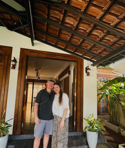 a man and a woman standing in front of a house at Nivartana Villa and Purana Ayurveda Center in Bentota