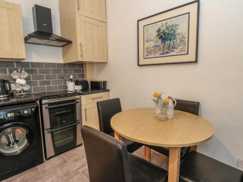 a kitchen with a wooden table and a table and chairs at Lismore in Crieff