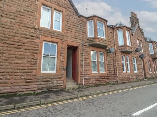 a row of brick houses on the side of a street at Lismore in Crieff