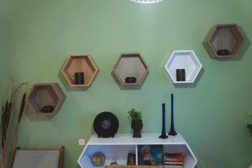 a room with a shelf with a bunch of wooden mirrors at Marvic House in Exaplátanos