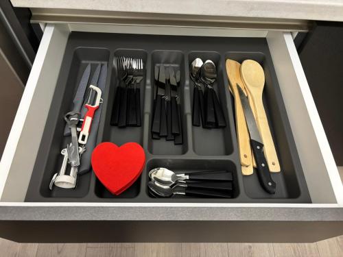 a drawer filled with kitchen utensils and a red heart at Dream - Large Apartament with FreeParking in a QuietArea just 10 minutes away from City Center in Bistriţa