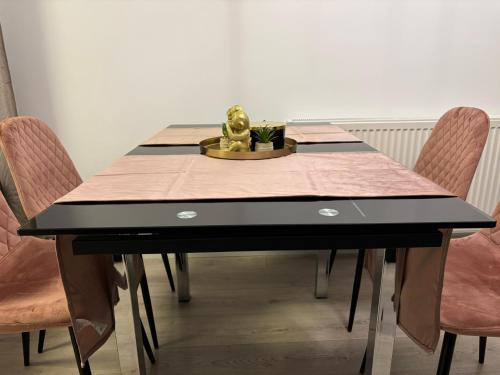 a dining room table with a gorilla statue on top of it at Dream - Large Apartament with FreeParking in a QuietArea just 10 minutes away from City Center in Bistriţa