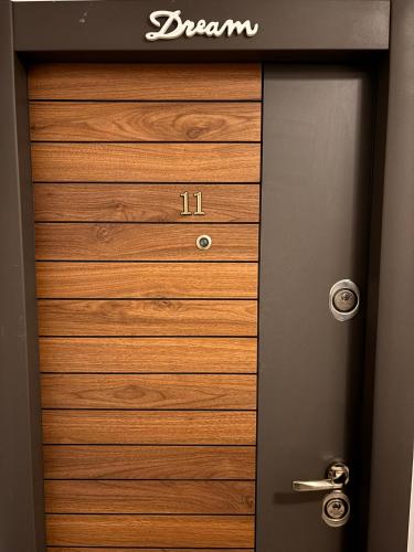 a wooden door with a sign on top of it at Dream - Large Apartament with FreeParking in a QuietArea just 10 minutes away from City Center in Bistriţa