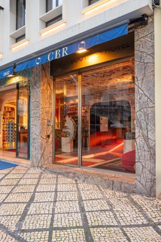 a store front of a building with glass windows at CBR Boutique Hotel - Coimbra in Coimbra