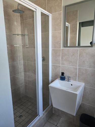 a bathroom with a shower and a sink at Sedgefield in Sedgefield
