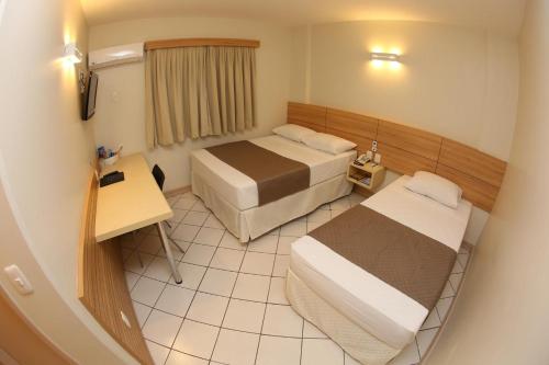 Postel nebo postele na pokoji v ubytování Hotel Caiuá Express Umuarama
