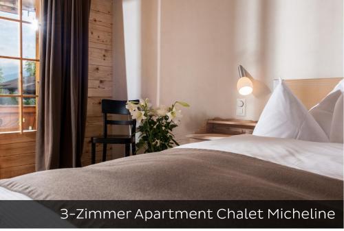 Postel nebo postele na pokoji v ubytování Hotel Arc-en-ciel Gstaad