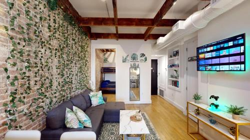 a living room with a large brick wall at Chic Penthouse with bus stop at doorstep - 15 Minutes to NYC in Hoboken