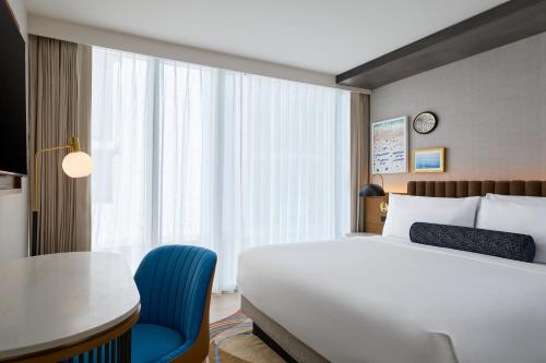 a hotel room with a bed and a table and a chair at Hyatt Centric South Beach Miami in Miami Beach