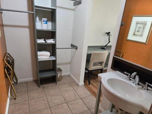 a bathroom with a sink and a mirror at Sage Motel in Vernal