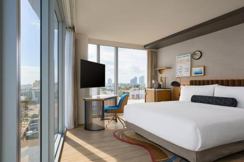 a hotel room with a bed and a large window at Hyatt Centric South Beach Miami in Miami Beach