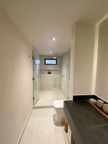 a bathroom with a shower and a toilet in it at Jungle Villa Tulum in Balcheil