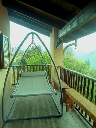 a swing on a porch with a bench at Villa Erbetta in Guardabosone