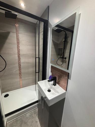 a bathroom with a sink and a shower and a tub at Luxury Living in Reading Town Centre in Reading