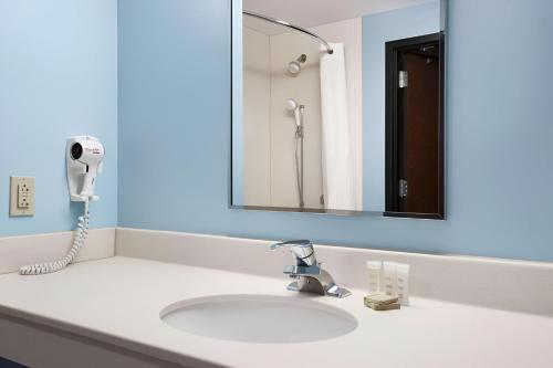 a bathroom with a sink with a phone on it at Super 8 by Wyndham Pennsville/Wilmington in Pennsville