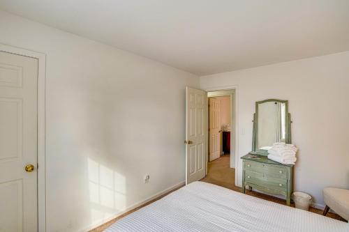 a bedroom with a bed and a mirror on the wall at Walk to Dining Downtown Lenox Guest House! in Lenox