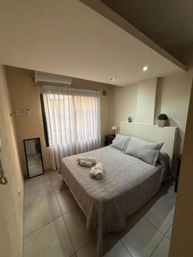 Ein Bett oder Betten in einem Zimmer der Unterkunft Rivadavia Departamentos