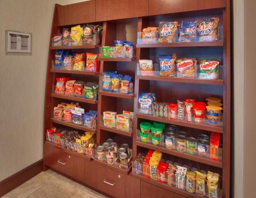 a refrigerator filled with lots of different types of food at Staybridge Suites Omaha 80th and Dodge by IHG in Omaha