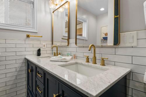 a bathroom with a sink and two mirrors at Bunny's Ranch - Sleeps 12, Pool Table, Ping Pong, Foosball in Big Bear City