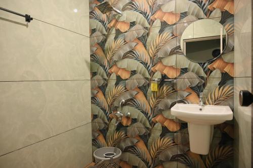 a bathroom with a toilet and a sink at You and Me in Varkala