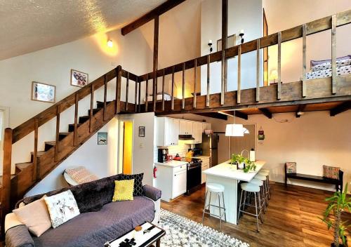 a living room with a couch and a kitchen at Cozy Ski Chalet in the Heart of the Poconos in Tobyhanna