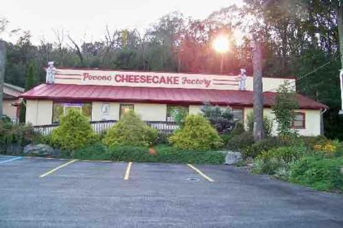 a restaurant with a parking lot in front of it at Cozy Ski Chalet in the Heart of the Poconos in Tobyhanna
