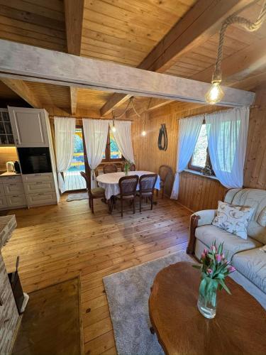 a living room with a table and a couch at Siedlisko Sapunki dom z duszą rybaka na Warmii in Bogdany